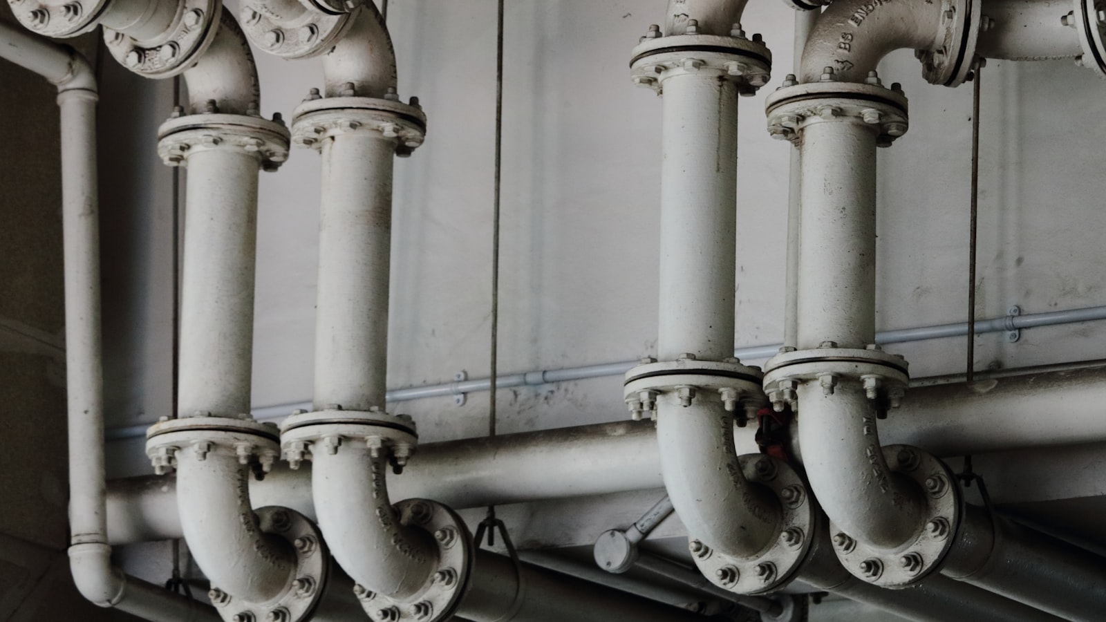 grayscale photography of metal pipes