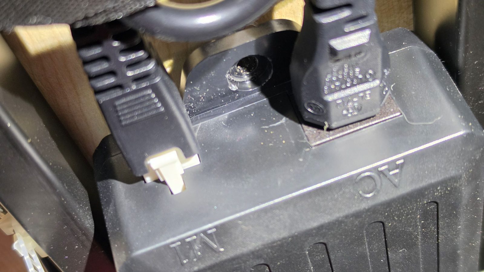 The control box mounted under the desk with motor and power cables plugged in